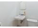 Compact bathroom featuring a simple sink, mirror, and toilet at 8350 40Th N Ave, St Petersburg, FL 33709