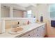 Spacious bathroom featuring double sinks, a large mirror, and tiled walls and shower at 8350 40Th N Ave, St Petersburg, FL 33709
