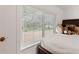 Bedroom with vinyl floors featuring a window with neighborhood views and filled with cozy stuffed animals at 8350 40Th N Ave, St Petersburg, FL 33709