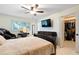 Bright bedroom featuring tile floors, ceiling fan, with a walk-in closet and a wall-mounted TV at 8350 40Th N Ave, St Petersburg, FL 33709