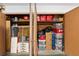 Open closet filled with packed boxes, storage bins, and household items on shelves at 8350 40Th N Ave, St Petersburg, FL 33709