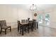 Bright dining room with a modern chandelier, table, and French doors to the exterior at 8350 40Th N Ave, St Petersburg, FL 33709
