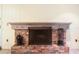 Classic brick fireplace with wood mantel and decorative iron accents adds warmth and charm to this home's interior at 8350 40Th N Ave, St Petersburg, FL 33709