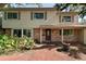 Charming two-story home featuring a brick facade, well-manicured landscaping, and a welcoming entryway at 8350 40Th N Ave, St Petersburg, FL 33709