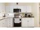 Updated kitchen featuring stainless steel appliances, white cabinets, and granite countertops at 8350 40Th N Ave, St Petersburg, FL 33709