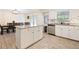 Open kitchen with a granite-topped island, stainless steel dishwasher, and an adjacent dining area at 8350 40Th N Ave, St Petersburg, FL 33709