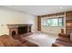 Inviting living room featuring a fireplace, built-in shelves, and a comfortable seating area at 8350 40Th N Ave, St Petersburg, FL 33709