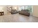 Comfortable living room featuring theater seating, wood-look tile floors, and bright natural light at 8350 40Th N Ave, St Petersburg, FL 33709
