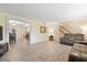 Open-concept living room featuring theater seating, wood-look tile floors, and views of the dining room and stairs at 8350 40Th N Ave, St Petersburg, FL 33709