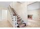 Interior staircase with carpeted steps and a view of the downstairs fireplace at 8350 40Th N Ave, St Petersburg, FL 33709