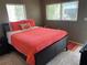 Comfortable bedroom with a vibrant orange bedspread and ample natural light at 8455 112Th St # 212, Seminole, FL 33772