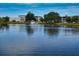 Scenic view of condo buildings overlooking a serene lake with a fountain and lush landscaping at 8455 112Th St # 212, Seminole, FL 33772