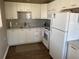Bright kitchen with white cabinets, gray tile backsplash, and updated appliances at 8455 112Th St # 212, Seminole, FL 33772