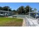 Well-maintained shuffleboard courts with seating areas and manicured landscaping in a sunny outdoor setting at 8455 112Th St # 212, Seminole, FL 33772