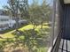 Serene view from screened patio, featuring lush greenery and building exteriors at 8455 112Th St # 212, Seminole, FL 33772
