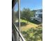 Scenic view from the screened patio of a well-maintained green lawn and community buildings at 8455 112Th St # 212, Seminole, FL 33772