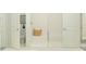 Modern bathroom featuring white tiled walls, glass shower door, and a comfortable bench at 9554 Minnow Ray Dr, Land O Lakes, FL 34638