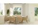 Sunlit dining area featuring modern table, natural light, and stylish decor at 9554 Minnow Ray Dr, Land O Lakes, FL 34638
