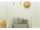 Neat entryway with woven bench, decorative pillows, and straw hat on the wall at 9554 Minnow Ray Dr, Land O Lakes, FL 34638