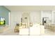 Bright living room with modern seating, a TV, view to outside, and an eat-in kitchen at 9554 Minnow Ray Dr, Land O Lakes, FL 34638