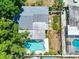 An aerial view of the house, the backyard, and the uniquely-shaped swimming pool at 9802 N Oregon Ave, Tampa, FL 33612