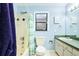 Cozy bathroom features a shower-tub combo with blue color accents, plus a mirrored vanity at 9802 N Oregon Ave, Tampa, FL 33612