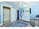 Bright Bedroom with blue walls, dresser, and a gray recliner chair at 9802 N Oregon Ave, Tampa, FL 33612