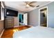 The bedroom features gleaming floors and a large screen television above a storage dresser at 9802 N Oregon Ave, Tampa, FL 33612
