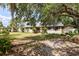 Charming single-story home with mature trees and landscaping at 9802 N Oregon Ave, Tampa, FL 33612