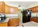 The well-maintained kitchen features wood cabinets and stone countertops at 9802 N Oregon Ave, Tampa, FL 33612