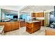 The lovely kitchen features wood cabinets, stone countertops and an island at 9802 N Oregon Ave, Tampa, FL 33612