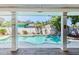 Inviting swimming pool and tropical backyard as viewed from covered patio at 9802 N Oregon Ave, Tampa, FL 33612