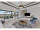 This living room features a modern tray ceiling, sliding glass doors, and stylish furnishings with a view at 10447 New Brunswick St, Port Charlotte, FL 33981