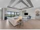 Bright living room with expansive sliding doors to the outdoor patio, showcasing modern design and comfortable seating at 10447 New Brunswick St, Port Charlotte, FL 33981