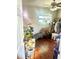 Cozy room with a window, ceiling fan, wood flooring, and plentiful plants at 10980 104Th Ave, Largo, FL 33778