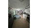 Open layout showing the kitchen with ample cabinet space and seamlessly connected living area at 10980 104Th Ave, Largo, FL 33778