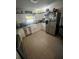 Bright kitchen with stainless steel appliances, tiled flooring, and white cabinets at 10980 104Th Ave, Largo, FL 33778