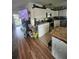 Well-equipped kitchen featuring white cabinetry, stainless steel appliances, and laminate wood flooring at 10980 104Th Ave, Largo, FL 33778
