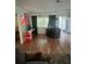 Living room area featuring laminate wood flooring, desk, and bright natural light at 10980 104Th Ave, Largo, FL 33778