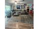 Cozy living room with a sectional sofa, stylish coffee table, and laminate wood flooring at 10980 104Th Ave, Largo, FL 33778