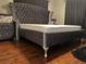 Main bedroom boasts hardwood floors, a tall velvet headboard, and matching nightstand at 10980 104Th Ave, Largo, FL 33778