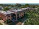 Aerial view of the condo buildings featuring screened in balconies and mature trees at 12900 Vonn Rd # D202, Largo, FL 33774
