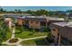Aerial view of a condo building featuring beautiful landscaping and mature trees at 12900 Vonn Rd # D202, Largo, FL 33774