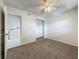 Neutral bedroom showcases carpeted floors, a closet, and a laundry room view for added convenience at 12900 Vonn Rd # D202, Largo, FL 33774