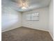 Cozy bedroom with neutral carpet, a window with blinds, and a ceiling fan at 12900 Vonn Rd # D202, Largo, FL 33774