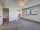 Spacious bedroom with carpet flooring and view to balcony at 12900 Vonn Rd # D202, Largo, FL 33774