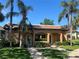 Exterior view of a charming cabana situated near a swimming pool, surrounded by lush landscaping at 12900 Vonn Rd # D202, Largo, FL 33774