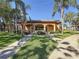 Charming community clubhouse with well-maintained landscaping and inviting walkway at 12900 Vonn Rd # D202, Largo, FL 33774