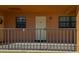 A welcoming condo entrance with sleek railings, a neutral color scheme, and clear unit number at 12900 Vonn Rd # D202, Largo, FL 33774