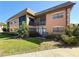 A two-story condo building featuring screened balconies and lush landscaping at 12900 Vonn Rd # D202, Largo, FL 33774
